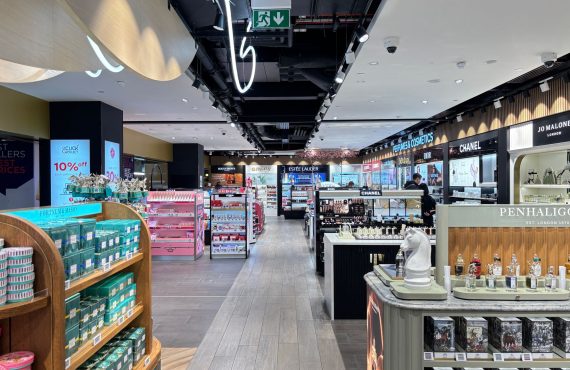 Bright cosmetics store interior showcasing luxury brands in London. Sleek and modern retail design.