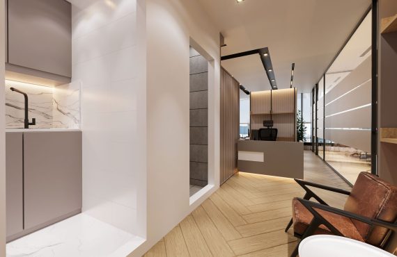 A stylish and contemporary office interior featuring marble and wood finishes.