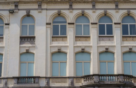 Beautiful historic building façade with arched windows in Oostende, Belgium.